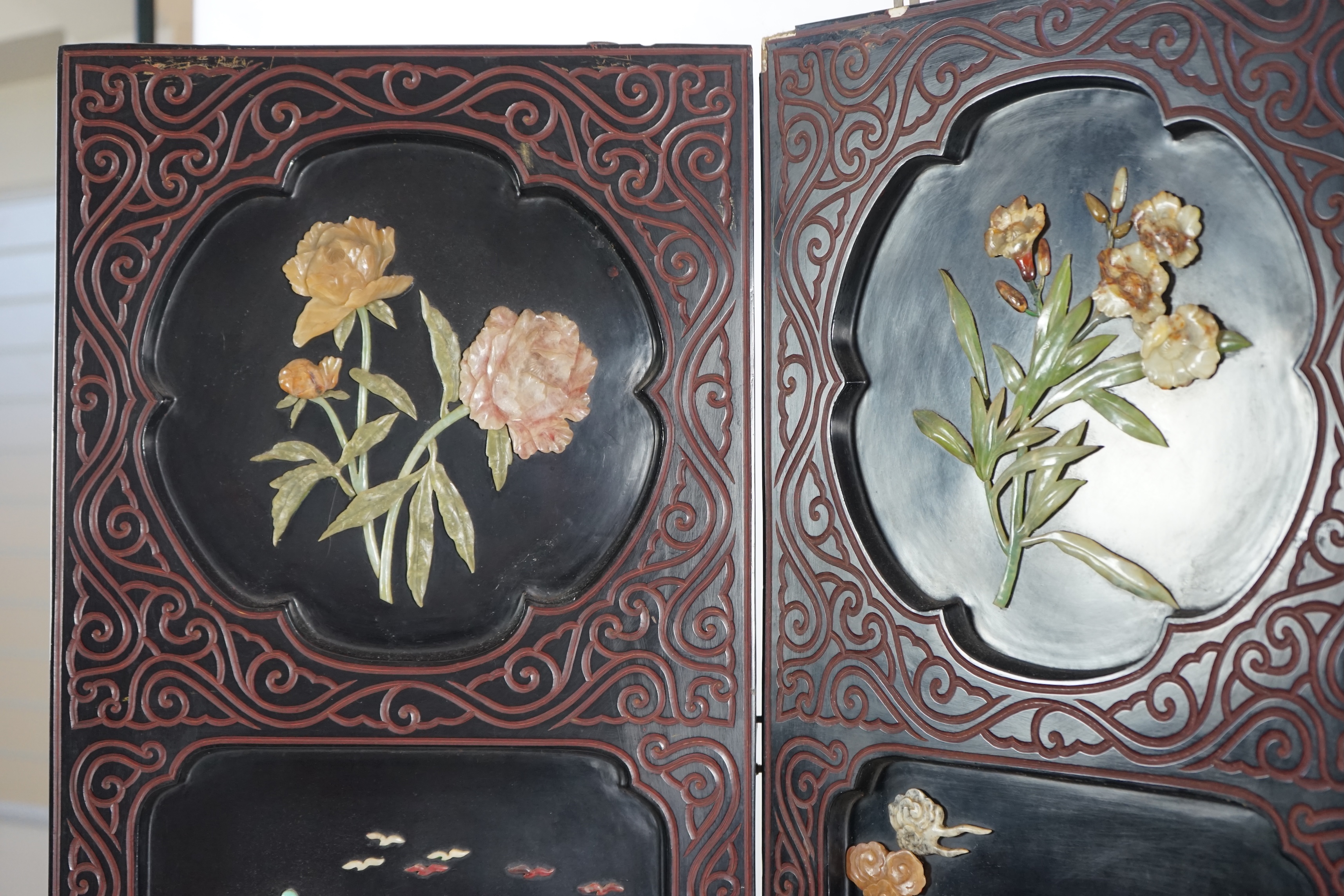 A Chinese tixi lacquer and carved soapstone overlaid six panel screen, mid 20th century